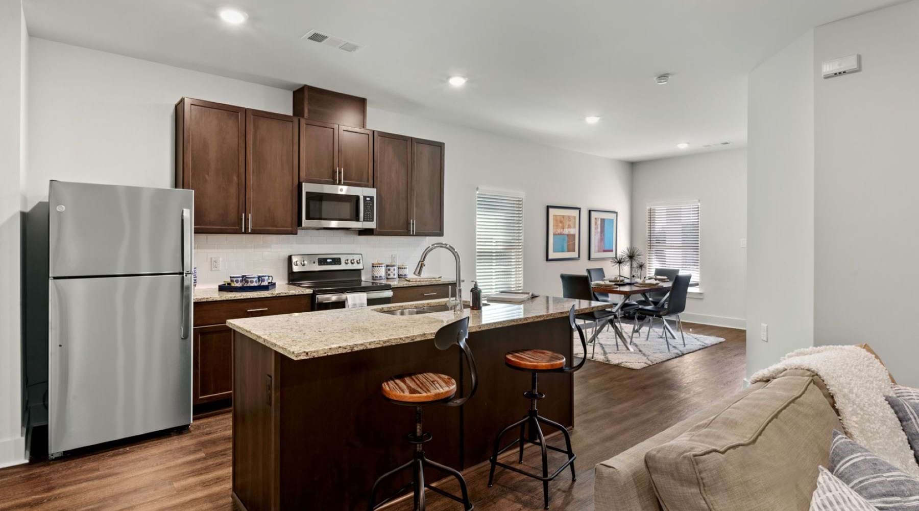 Model kitchen at Hardy Springs 55 and older community in Dallas, GA, featuring stainless steel appliances.