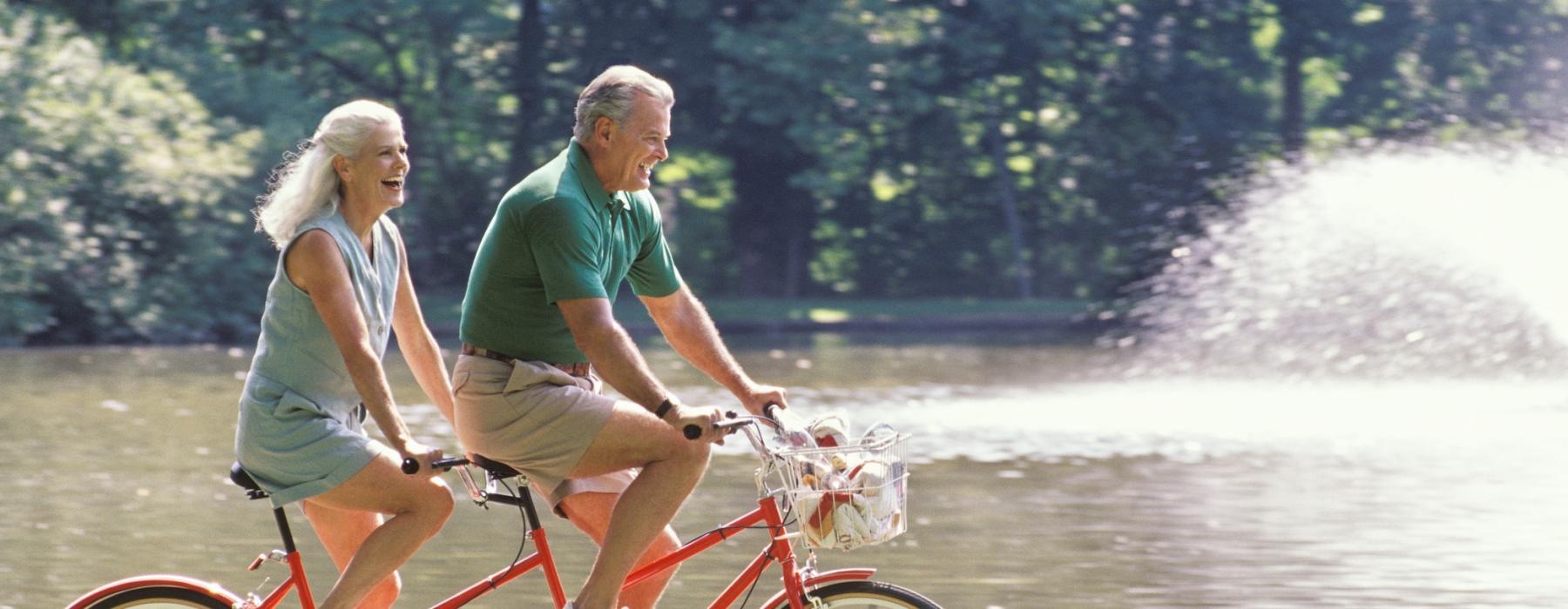 a man and a woman riding a bicycle