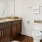 Model bathroom at Hardy Springs 55 and over community in Dallas, GA, featuring granite counters and wood grain cabinetry.