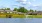 a body of water with houses and trees around it
